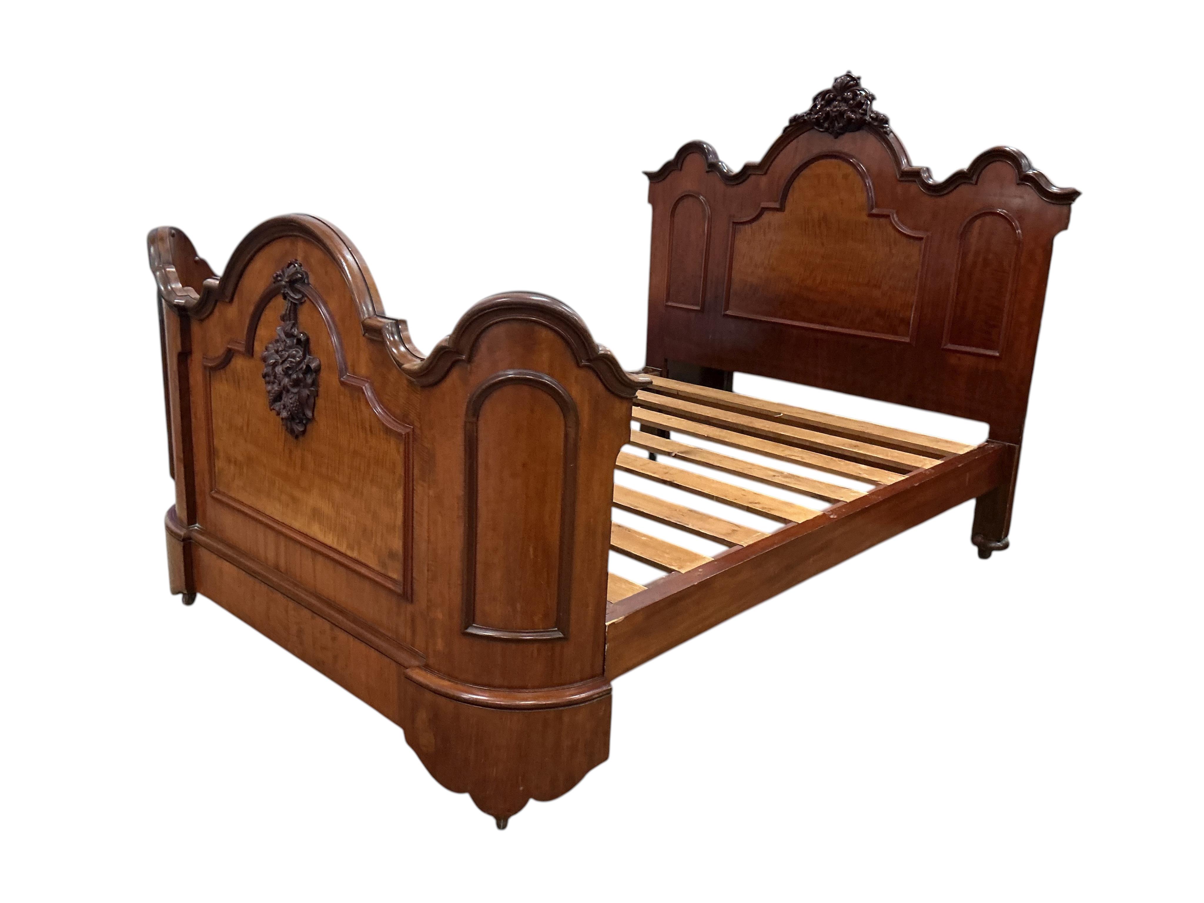 A Victorian carved mahogany double bed frame, width 154cm, height 156cm